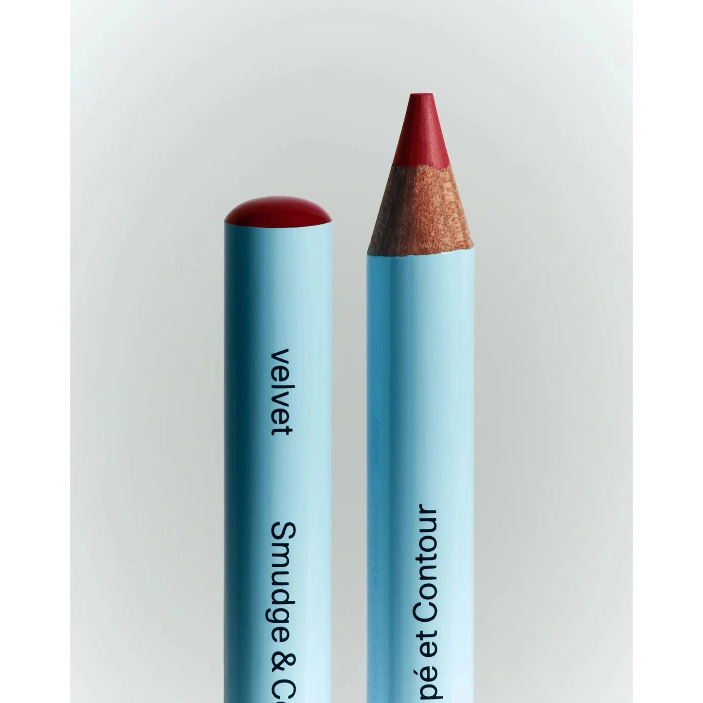 A pencil with a red color next to it.