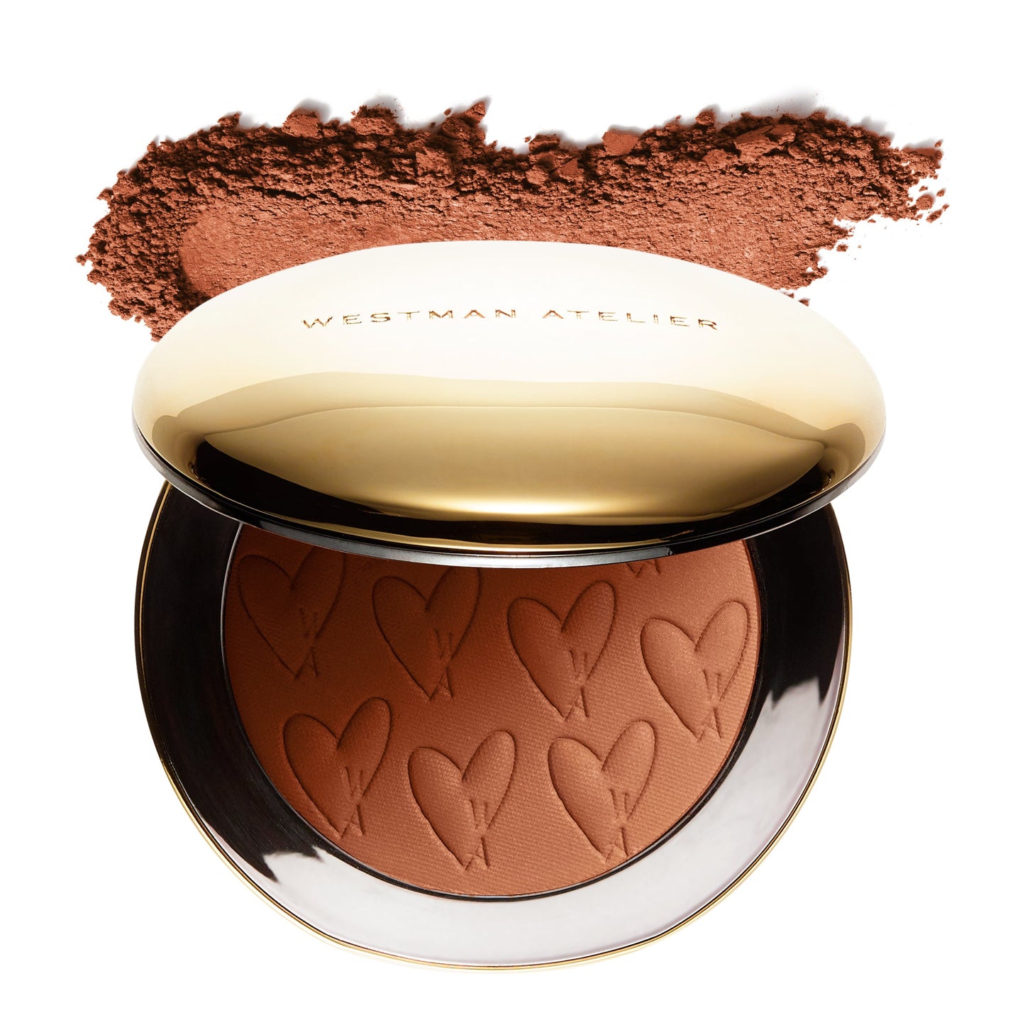 Westman atelier pressed powder compact with embossed hearts and cosmetic powder sprinkled above.