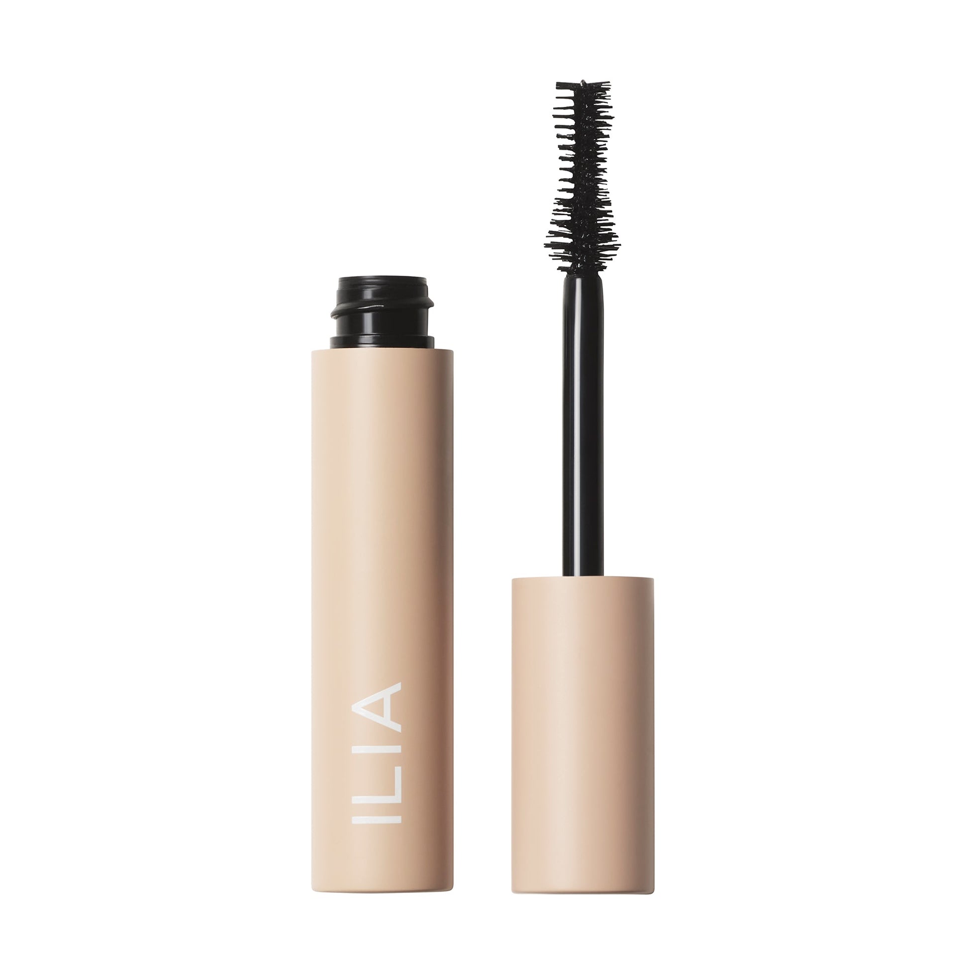 A tube of ilia brand mascara with its brush applicator displayed alongside it.
