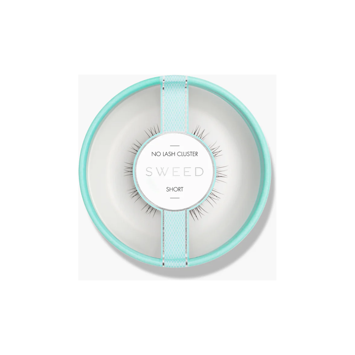 A set of false eyelashes presented on a plate, resembling a minimalist dining setting.