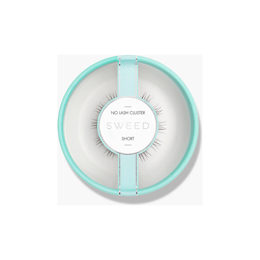 A set of false eyelashes presented on a plate, resembling a minimalist dining setting.